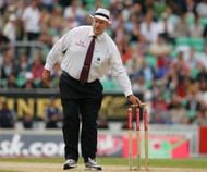 Umpire takes bails off